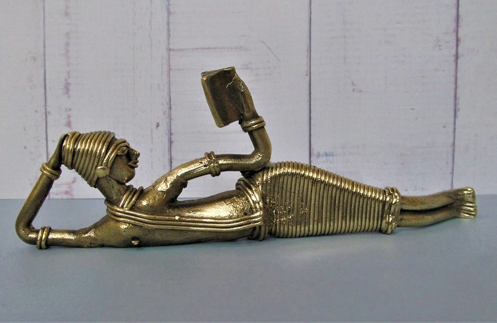 collectible metal handicraft of lady lying and reading